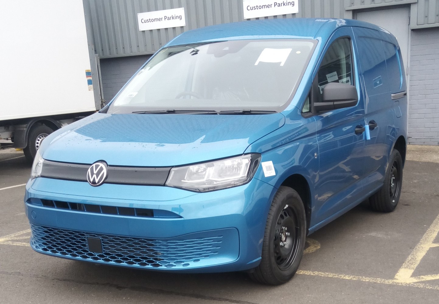 Blue cargo van with modern grille and sharp headlights