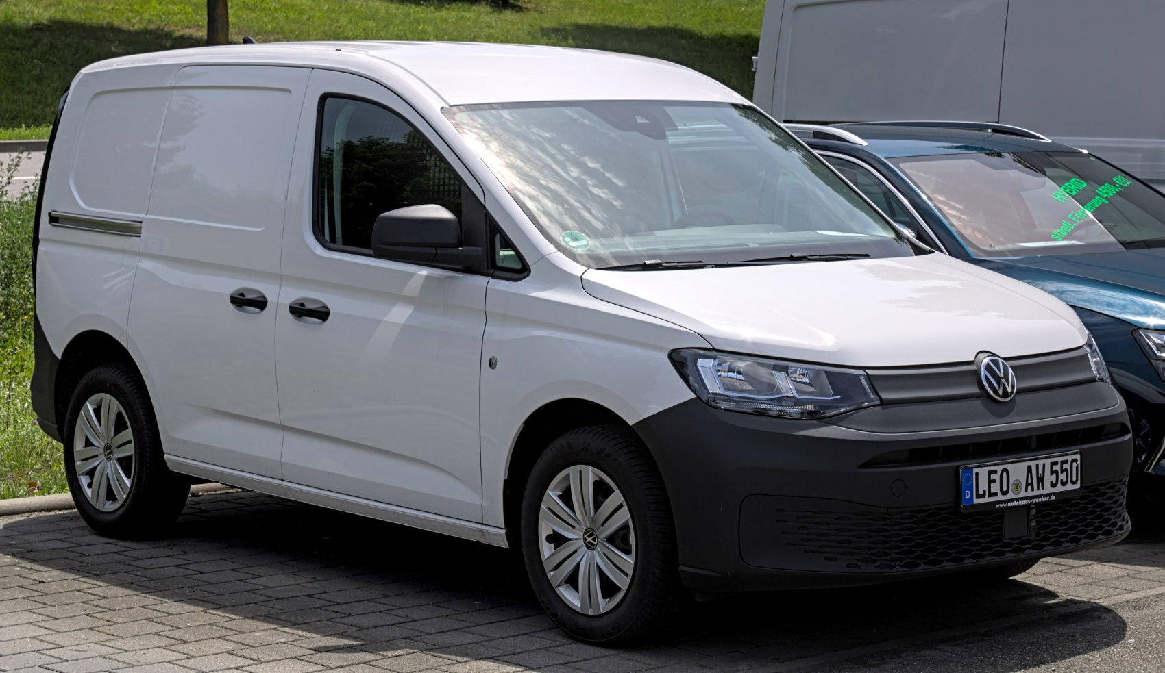 White compact cargo van with modern headlights and front grille.