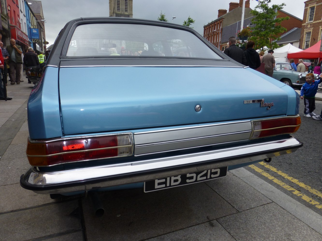 Close-up of vintage car rear with tail lights and bumper.
