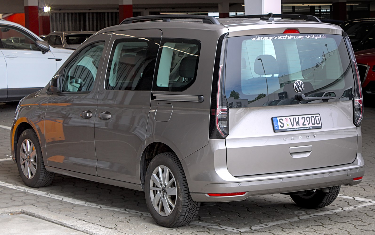 Rear and side view featuring sliding door and vertical taillights