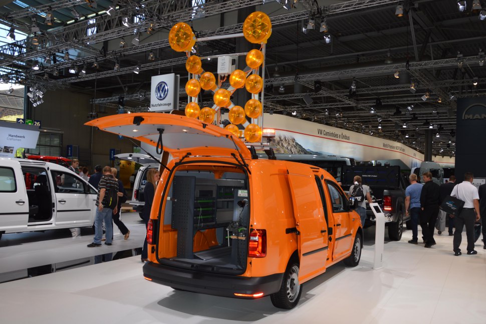 Orange utility panel van with open rear and interior shelving