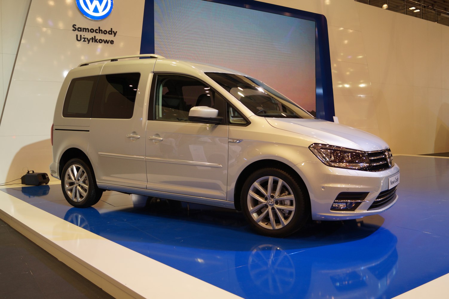 Side view of a white multi-purpose vehicle with alloy wheels.