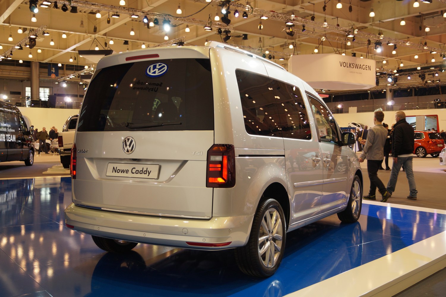 Rear view of a silver MPV with tinted windows and modern taillights