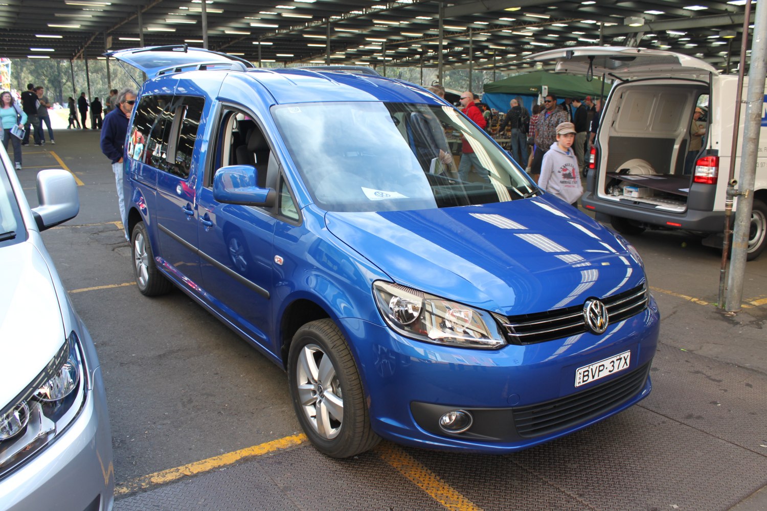 Blue Volkswagen MPV front angle with headlights and alloy wheels