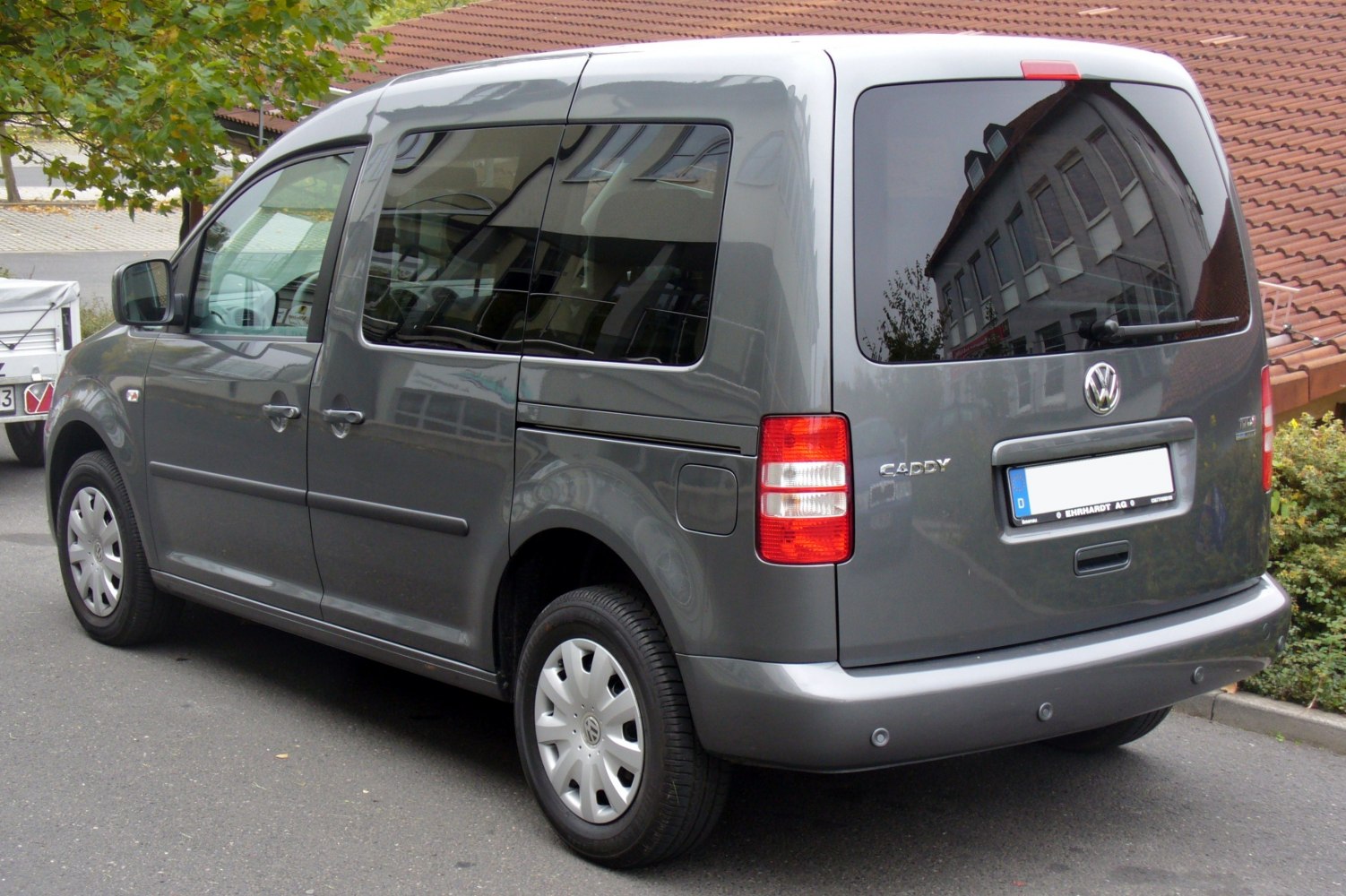 Rear and side view of a compact van with tinted windows and sliding door