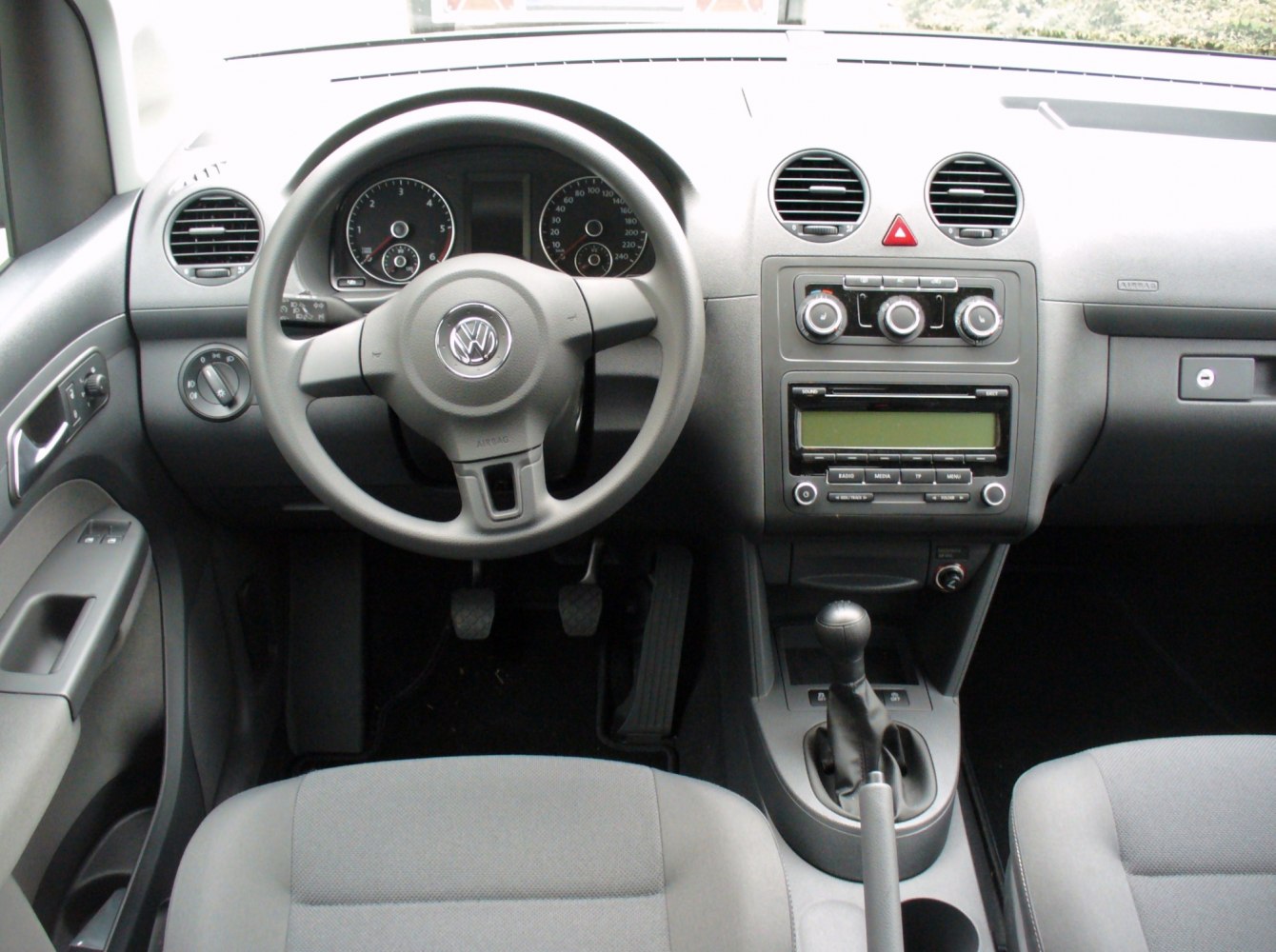 Dashboard and steering wheel interior view with center console and gear shift