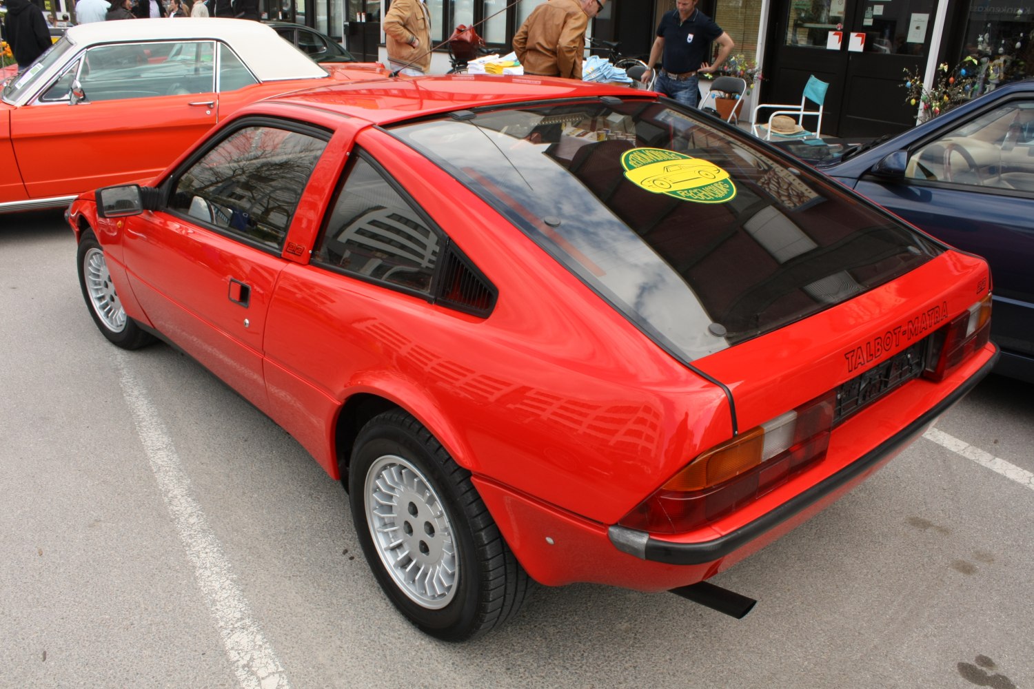Red sports coupe with rear hatch and angular design