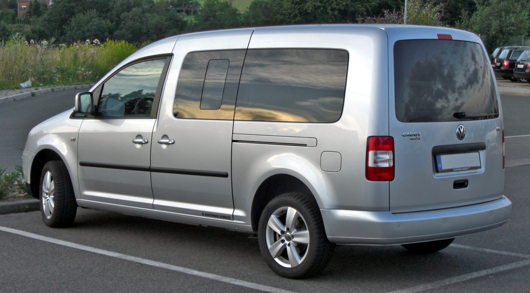 Silver van with tinted windows and alloy wheels viewed from rear side