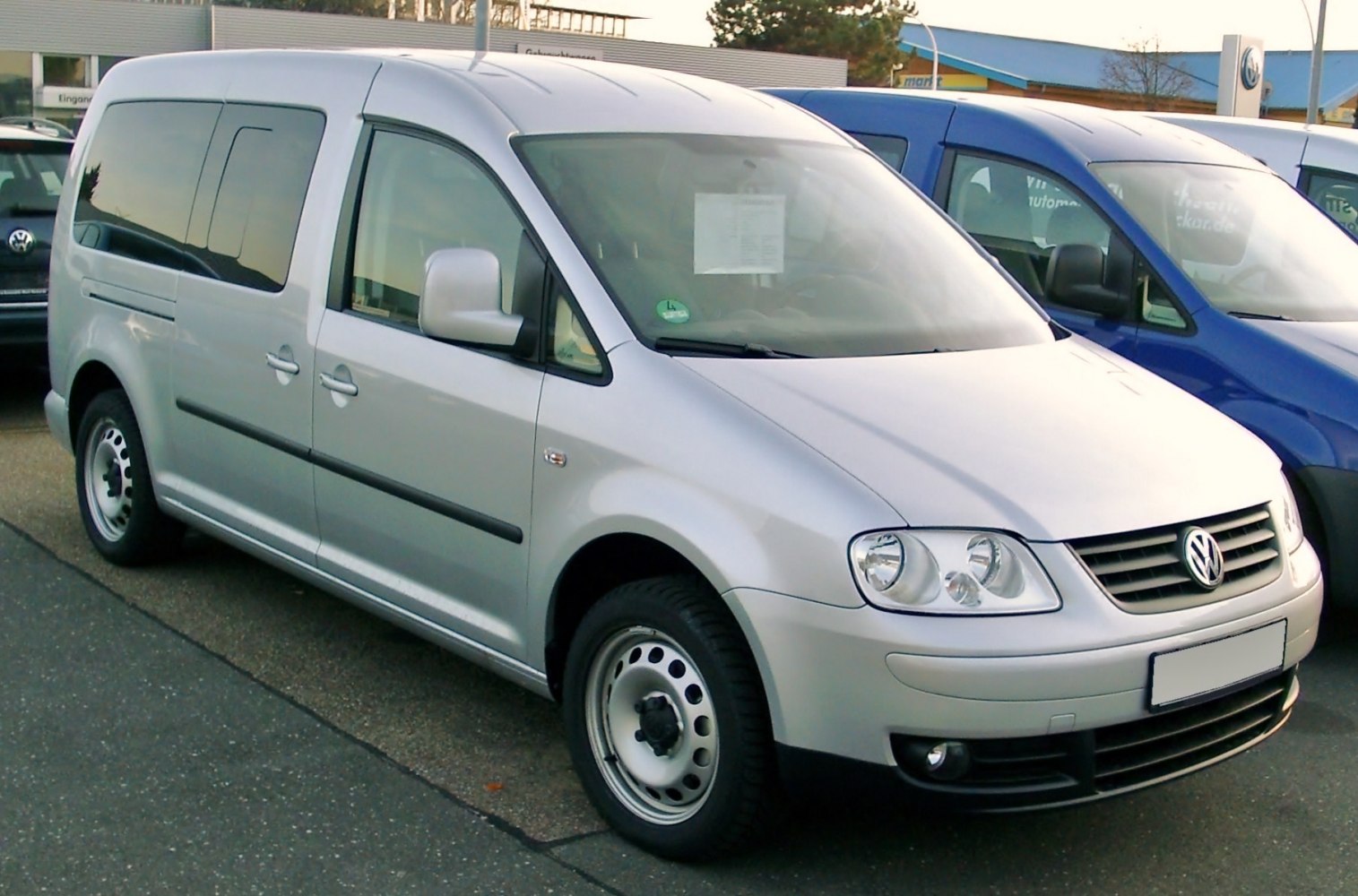 Silver compact van front side angle with steel rims and sliding door