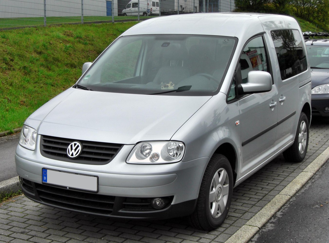 Silver compact MPV with front headlights and alloy wheels