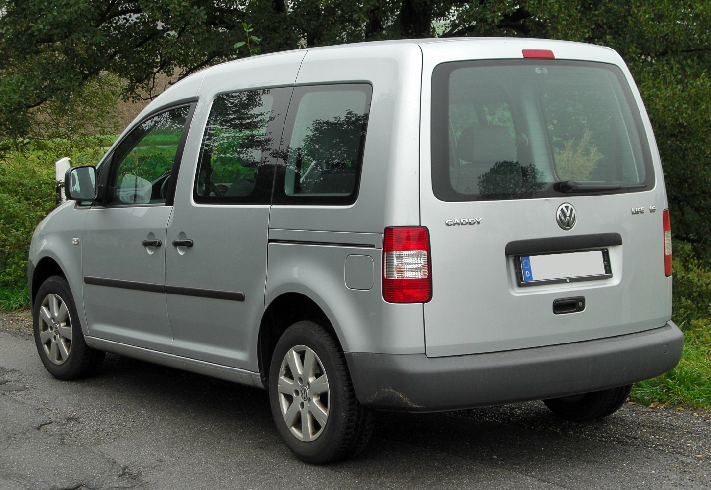 Rear side view of a compact light commercial van with sliding door and large rear window