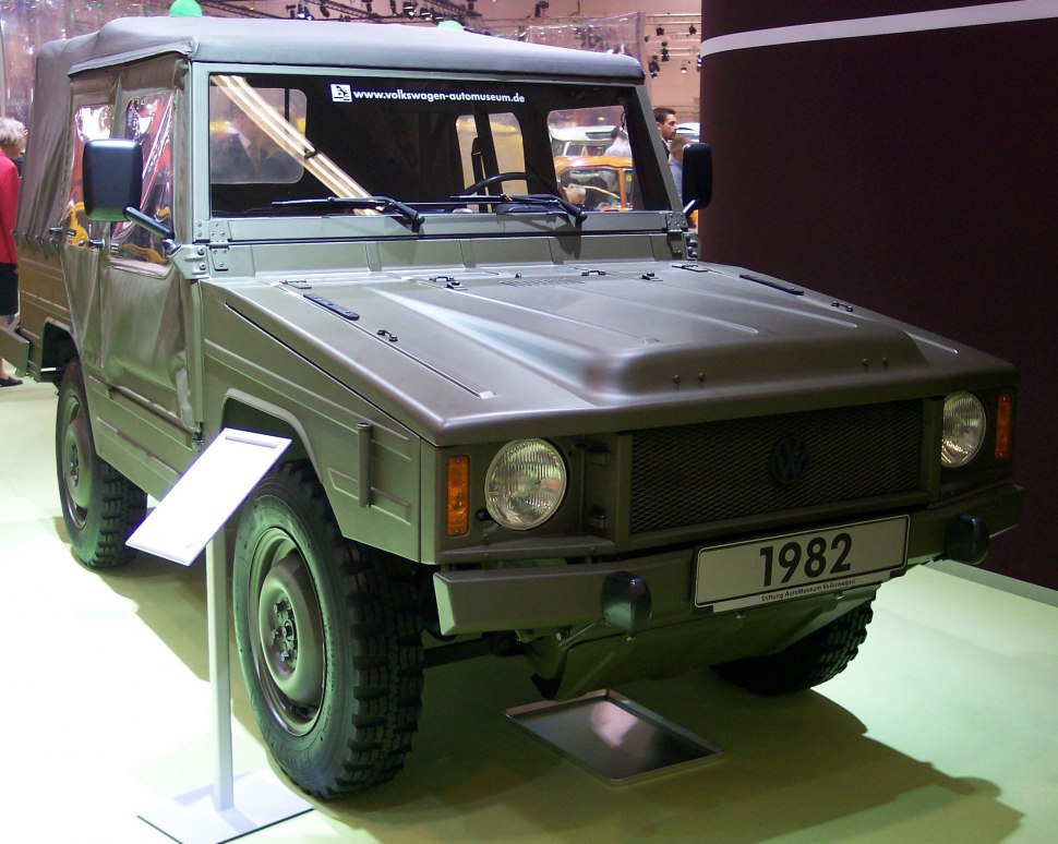 Military-style utility vehicle with canvas roof and off-road tires