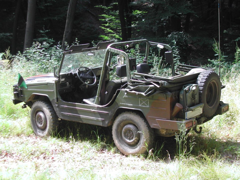 Open-top off-road utility vehicle with spare tire and canvas cover