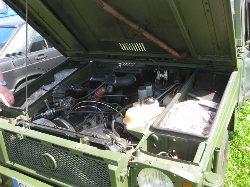 Engine bay with open hood and visible mechanical components.