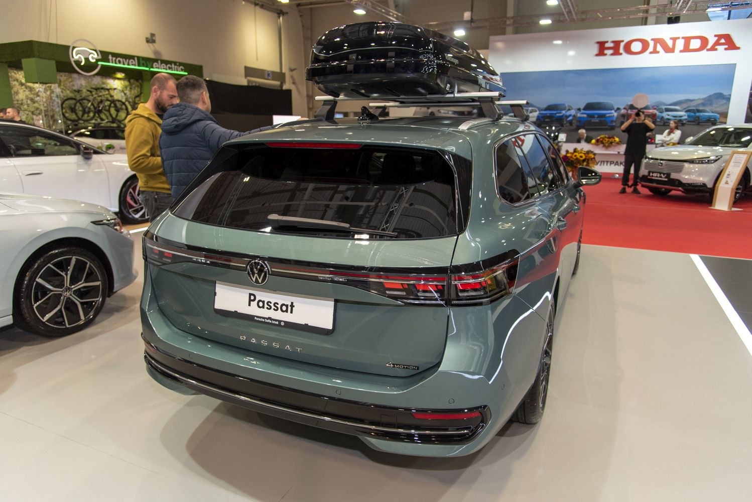 Rear view of a station wagon with roof cargo box and sleek tail lights