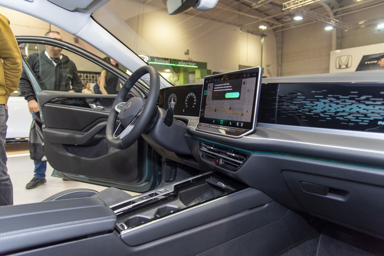 Digital dashboard and touchscreen infotainment system with steering wheel in car interior