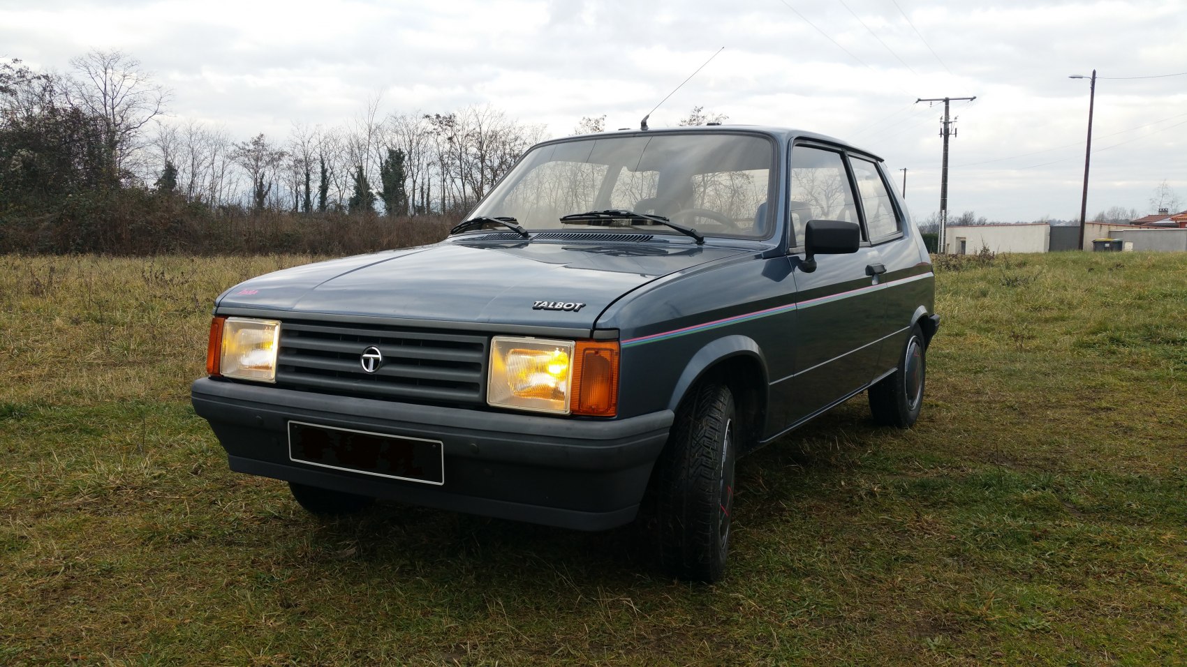 Classic compact hatchback front with headlights and grille