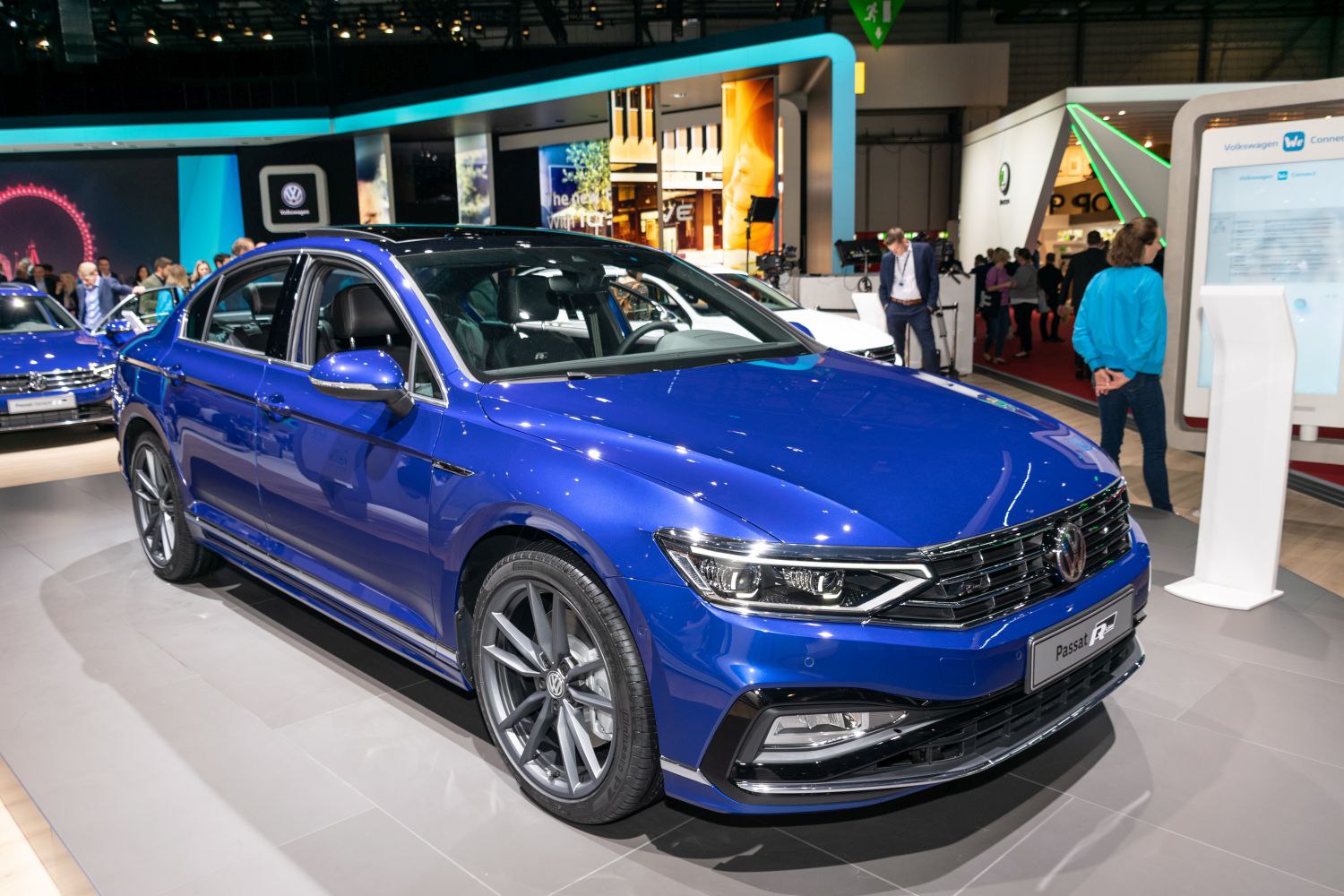 Blue mid-size sedan with LED headlights and sporty alloy wheels.