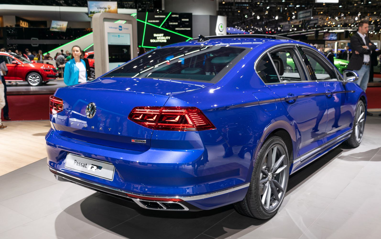 Rear view of blue sedan with modern taillights and dual exhausts