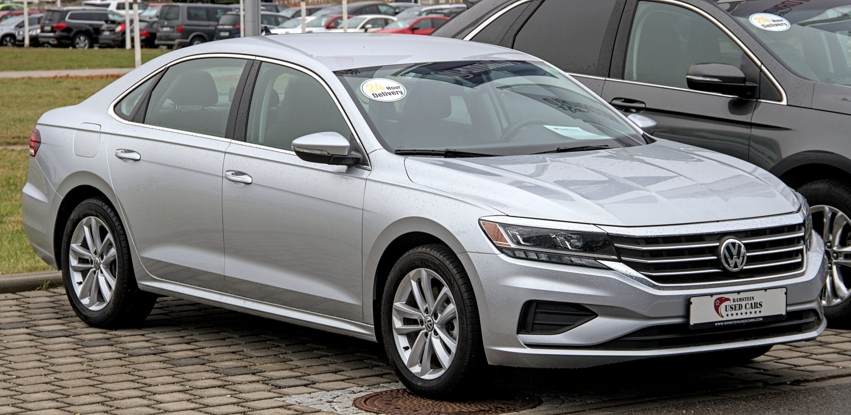 Silver sedan with front grille and alloy wheels