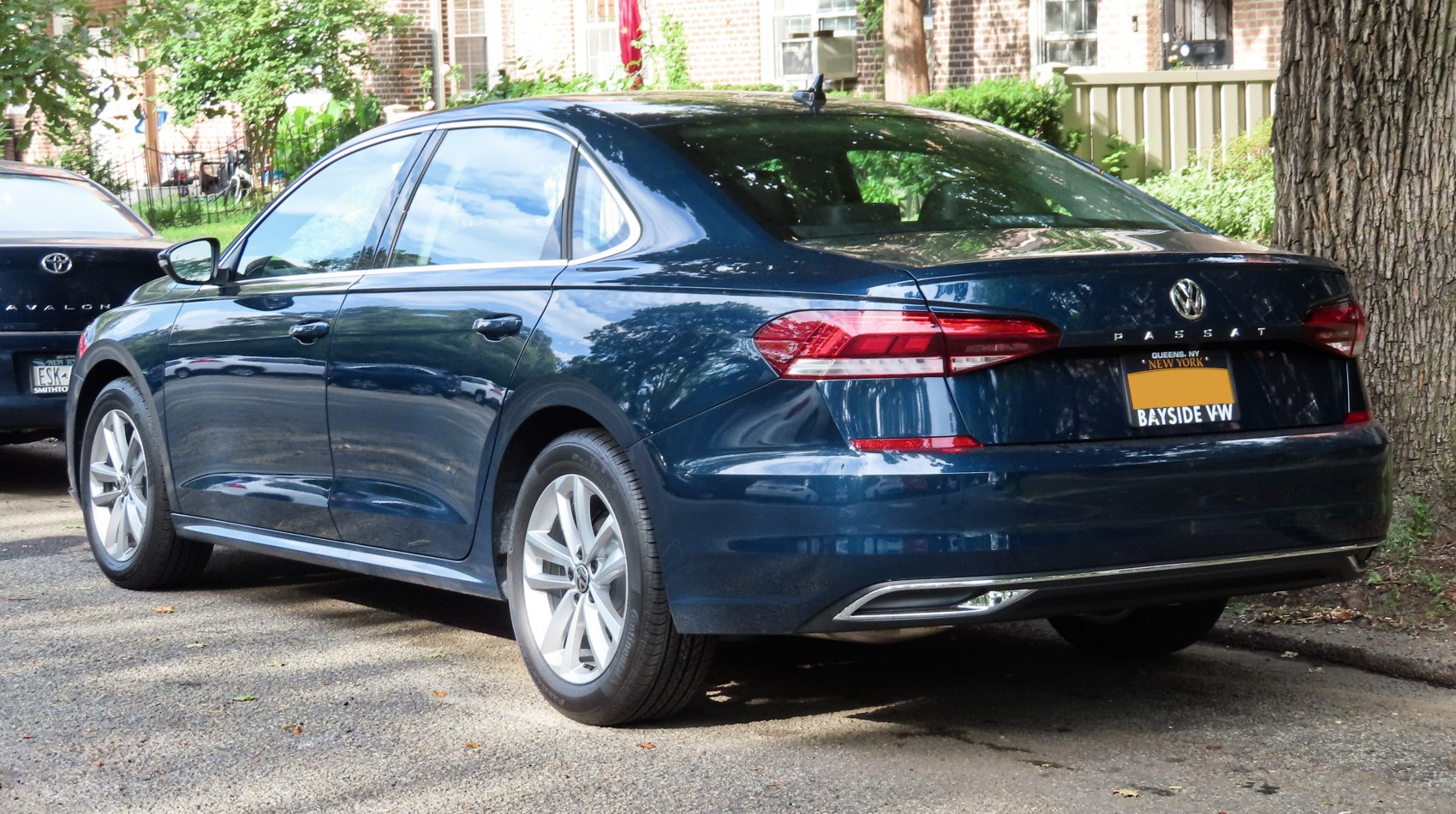 Rear side profile of mid-size sedan with distinct taillights and alloy wheels