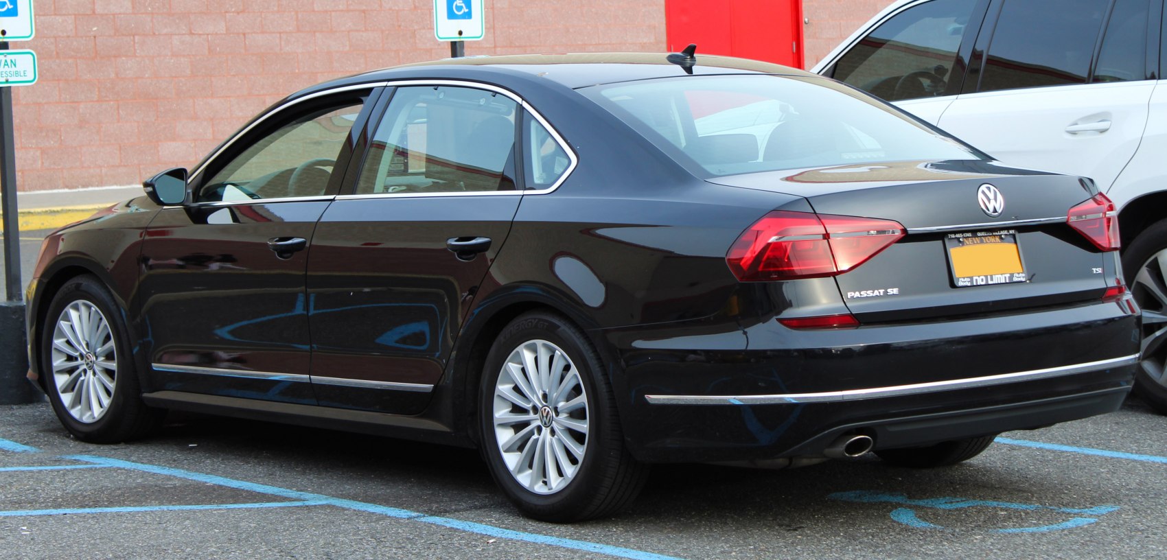 Rear side view of sedan with alloy wheels and distinct taillights