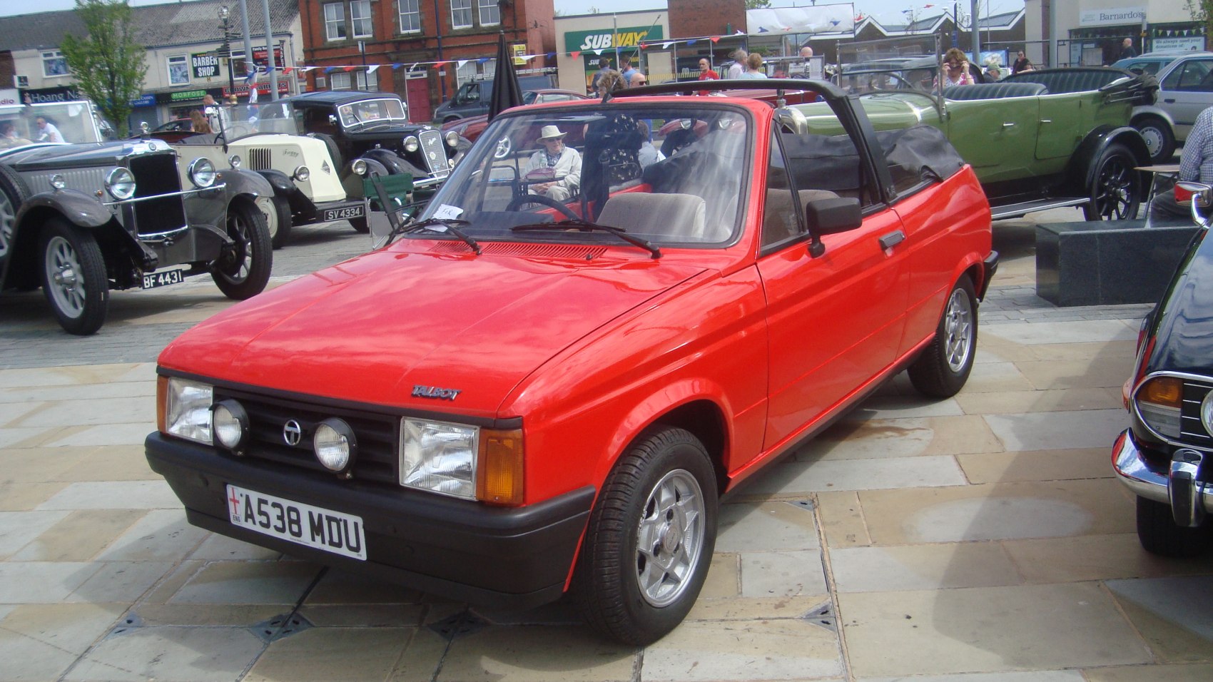 Red compact convertible with soft top and classic 1980s design