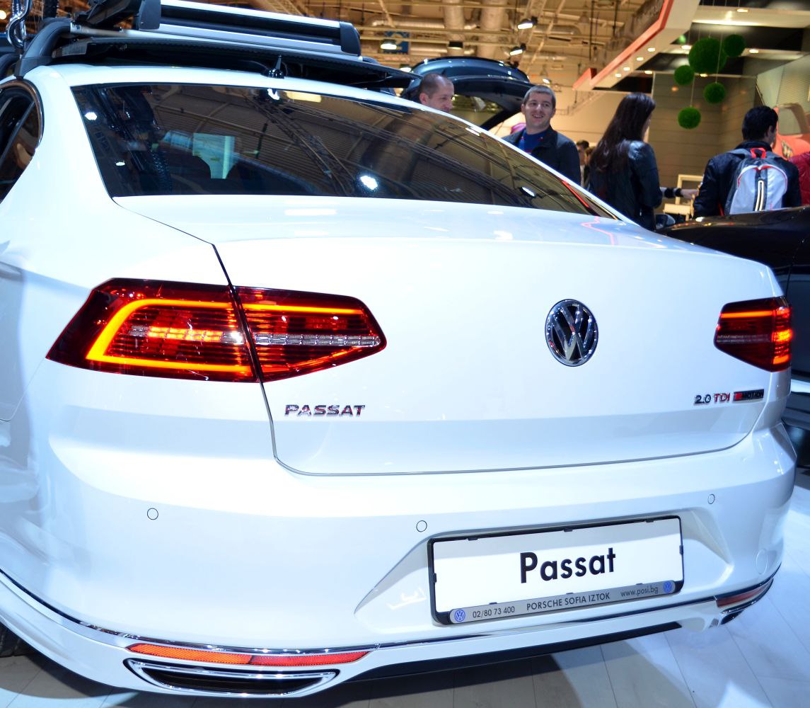 Rear view of white sedan with illuminated LED taillights and 2.0 TDI badge.