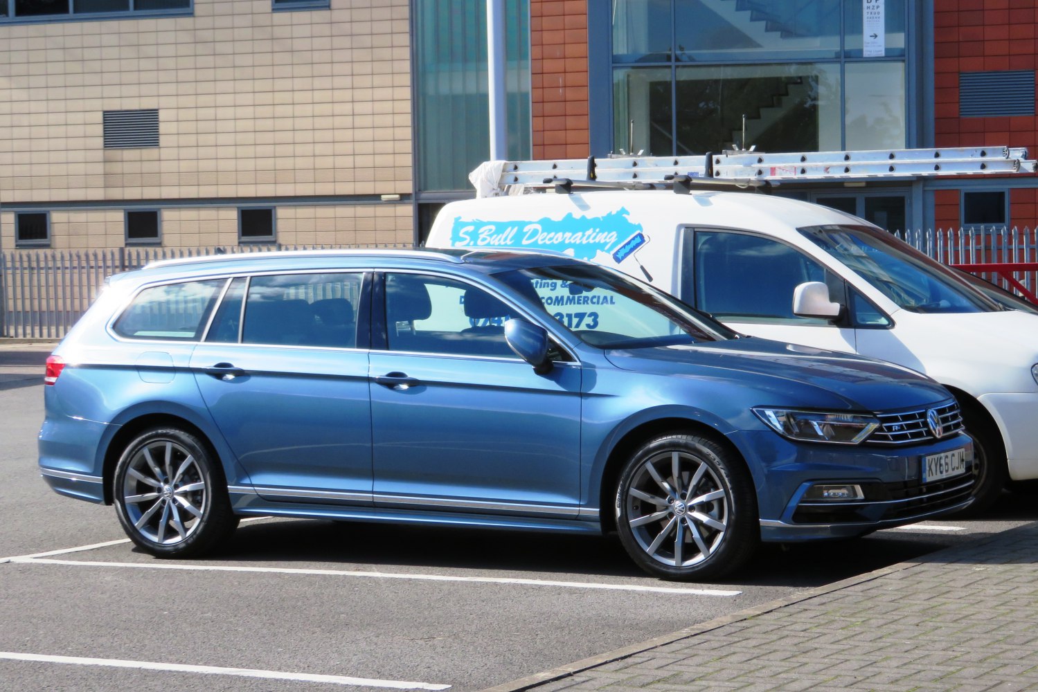 Side profile of a sleek estate car with sporty alloy wheels.