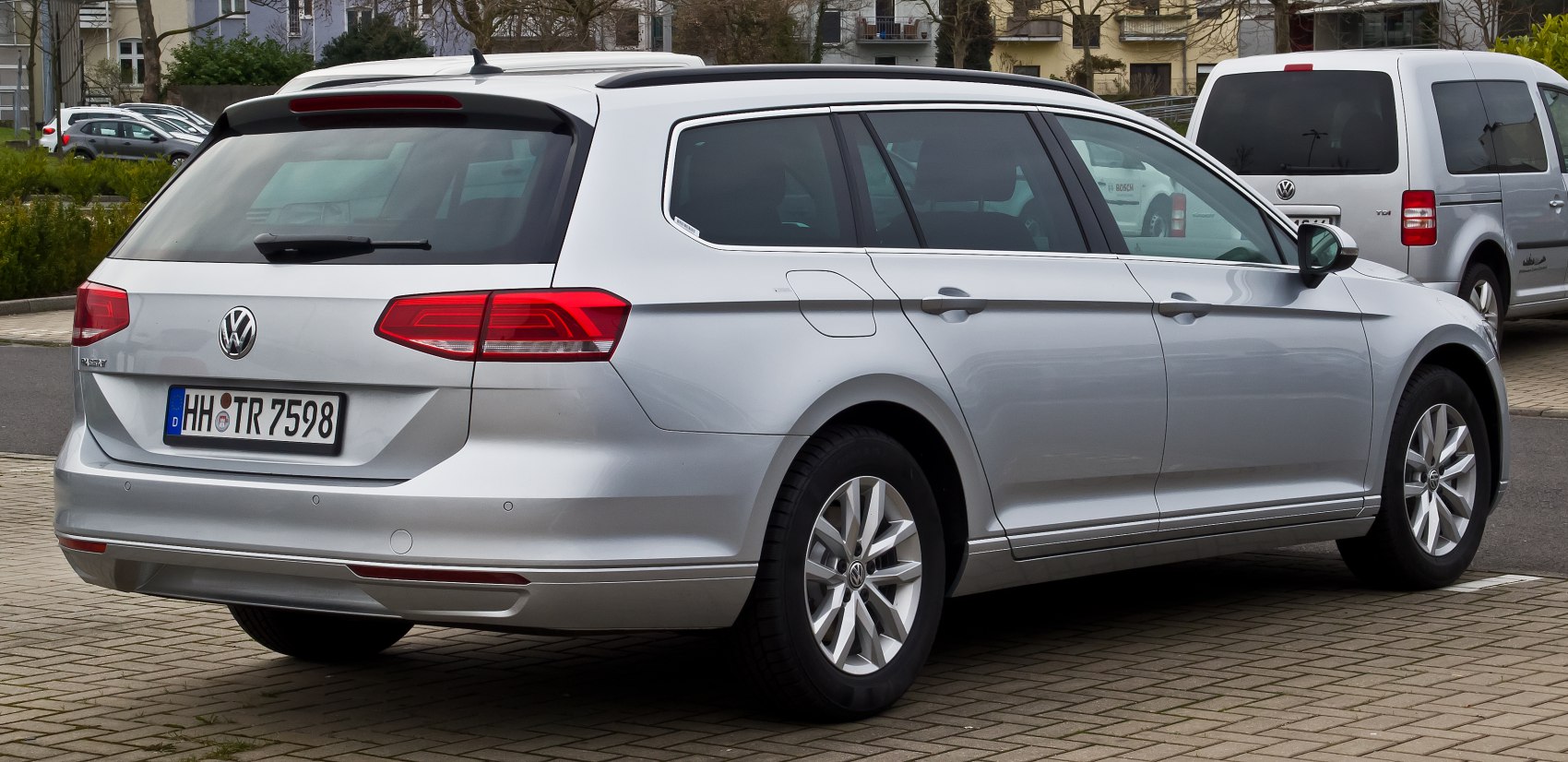 Silver station wagon rear side with red tail lights and alloy wheels