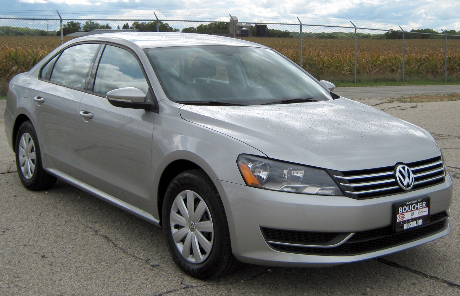 Silver mid-size sedan front-side view with halogen headlights and alloy wheels
