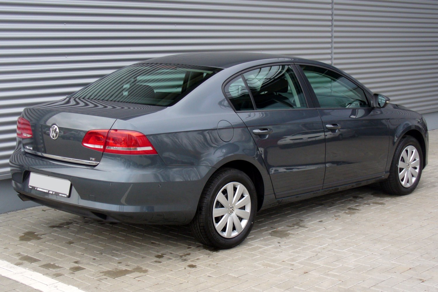 Rear view of sedan with taillights and alloy wheels