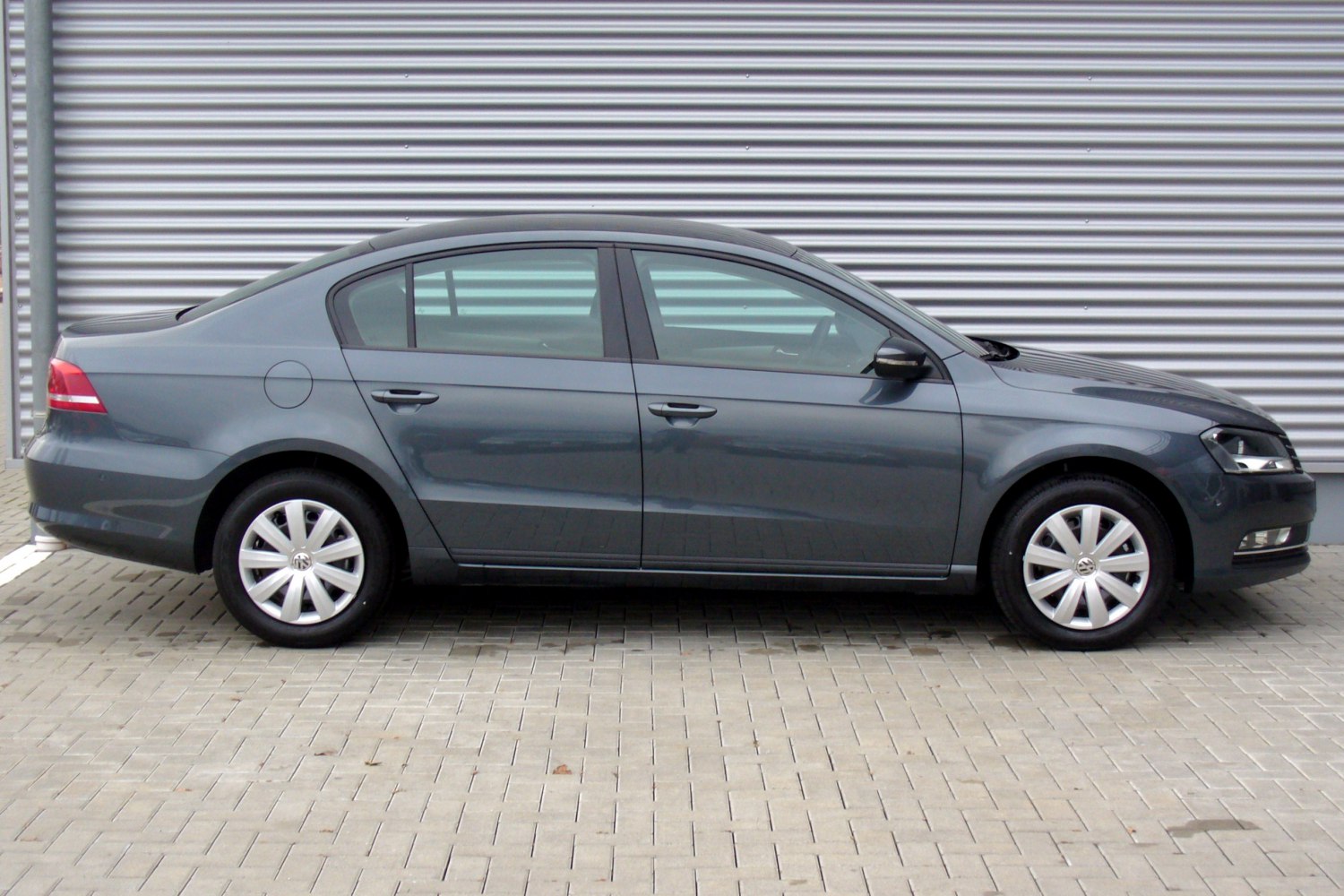 Side profile of four-door sedan with alloy wheels and side mirrors