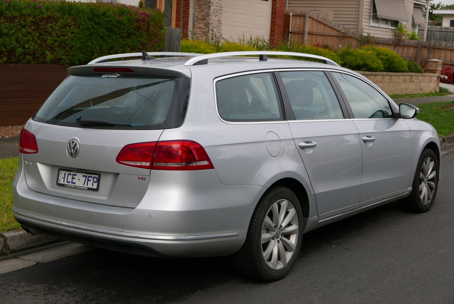 Silver station wagon rear side view with roof rails and tail lights