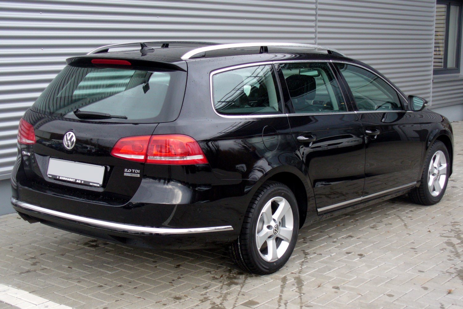 Rear and side view of a wagon with prominent tail lights and roof rails