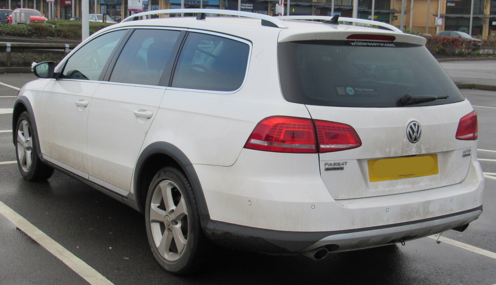 Rear and side view of a station wagon with roof rails and rugged wheel arches.