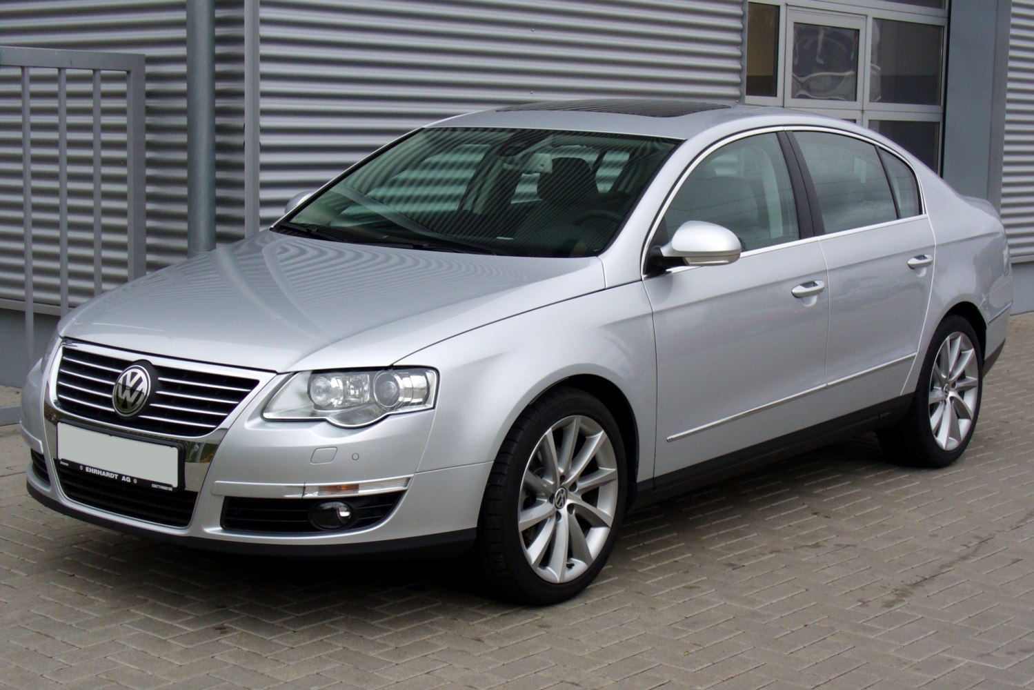 Silver sedan with chrome grille and alloy wheels front side view
