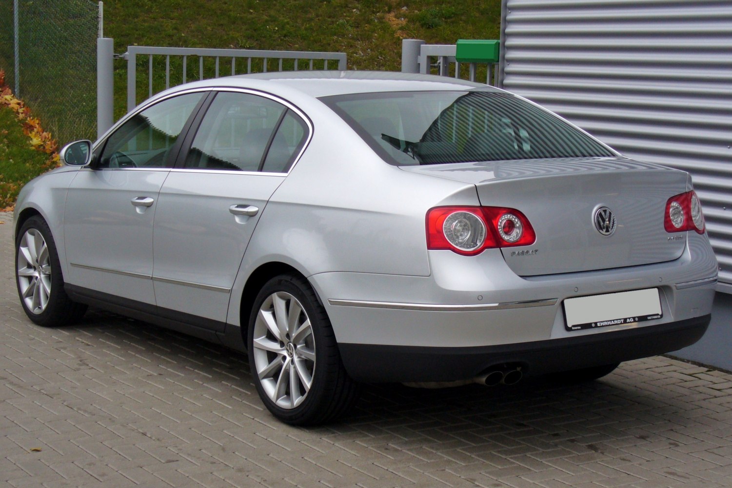 Silver sedan rear side view with distinct tail lights and alloy wheels
