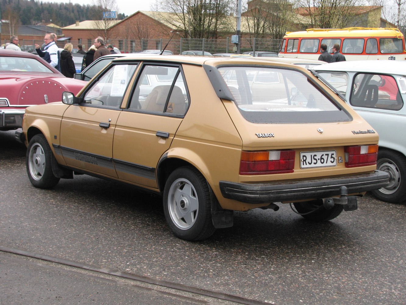 Rear view of a classic hatchback with rear spoiler and rectangular taillights