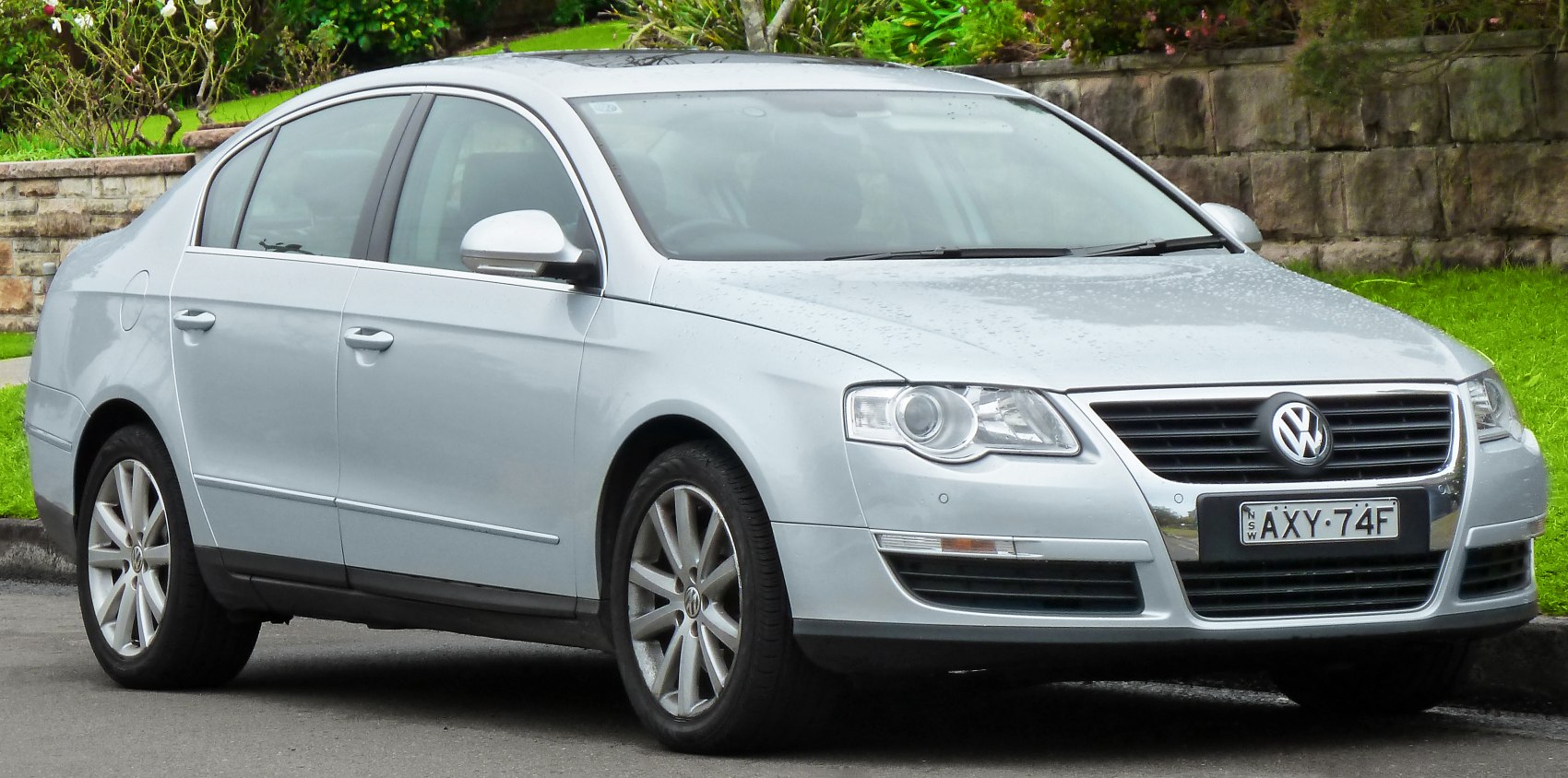 Silver mid-size sedan with front grille and alloy wheels