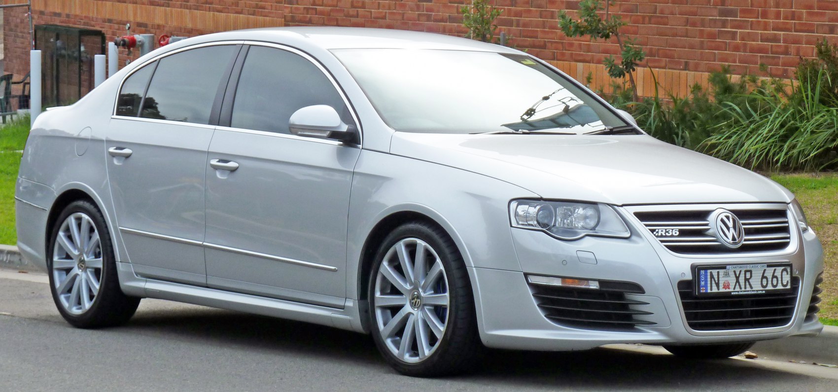 Silver sedan with prominent front grille and multi-spoke alloy wheels