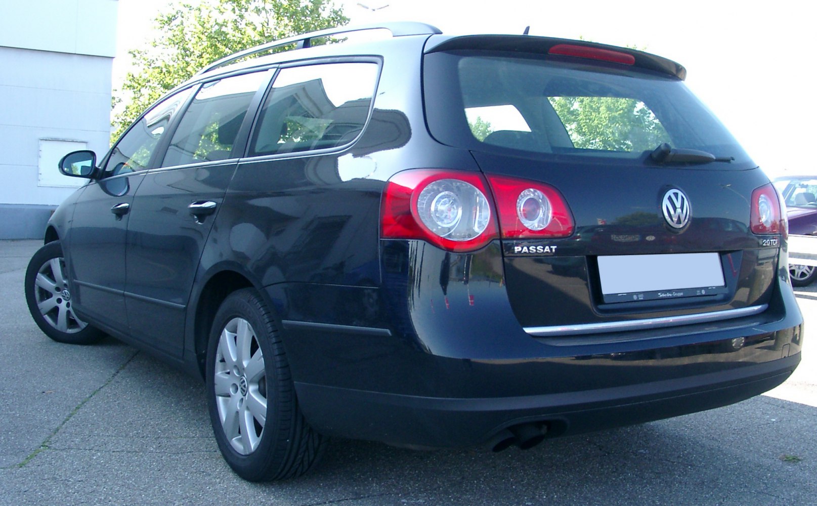 Rear view of a station wagon with distinctive taillights and roof rails