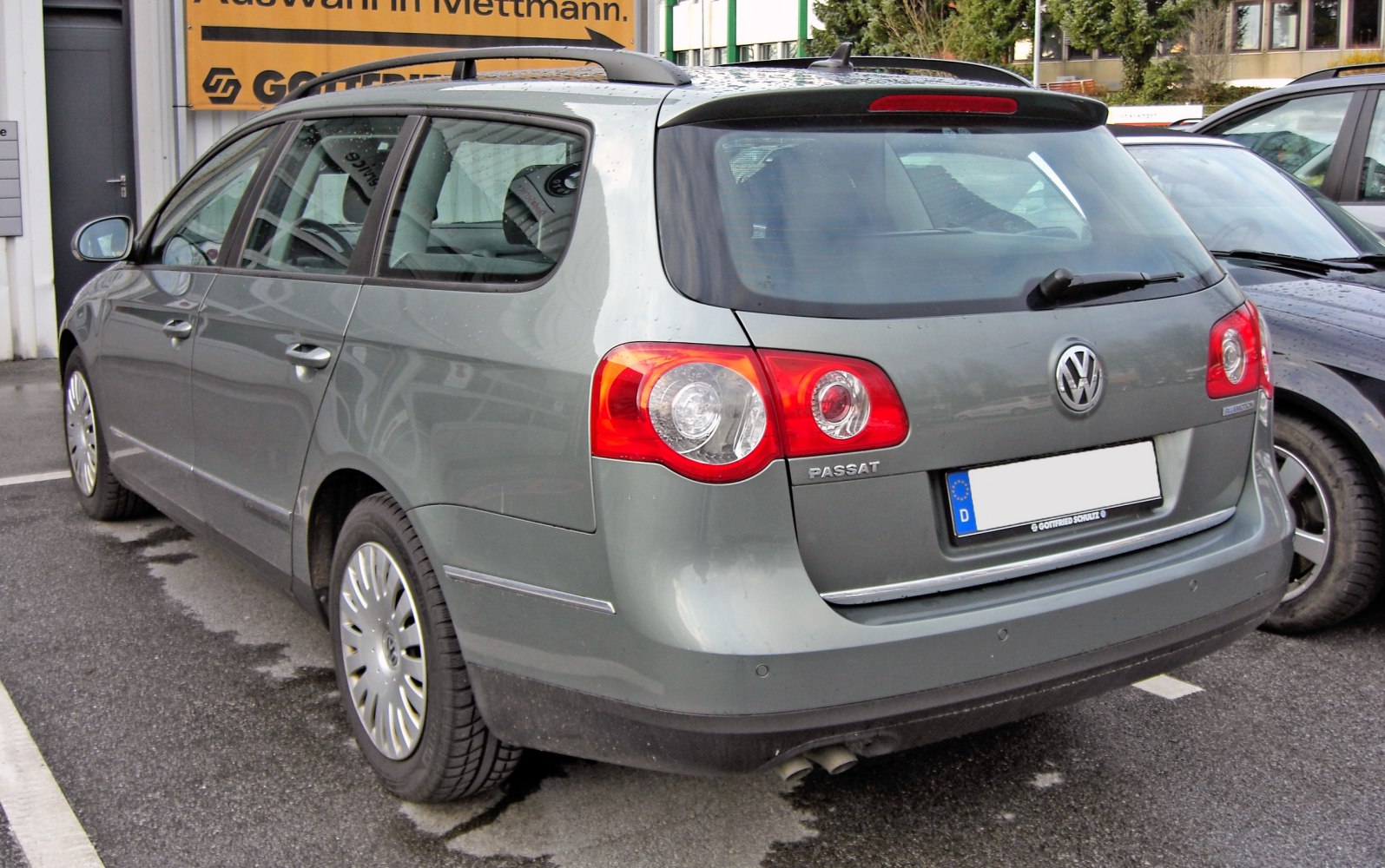 Rear and side view of a station wagon with distinct tail lights and roof rails