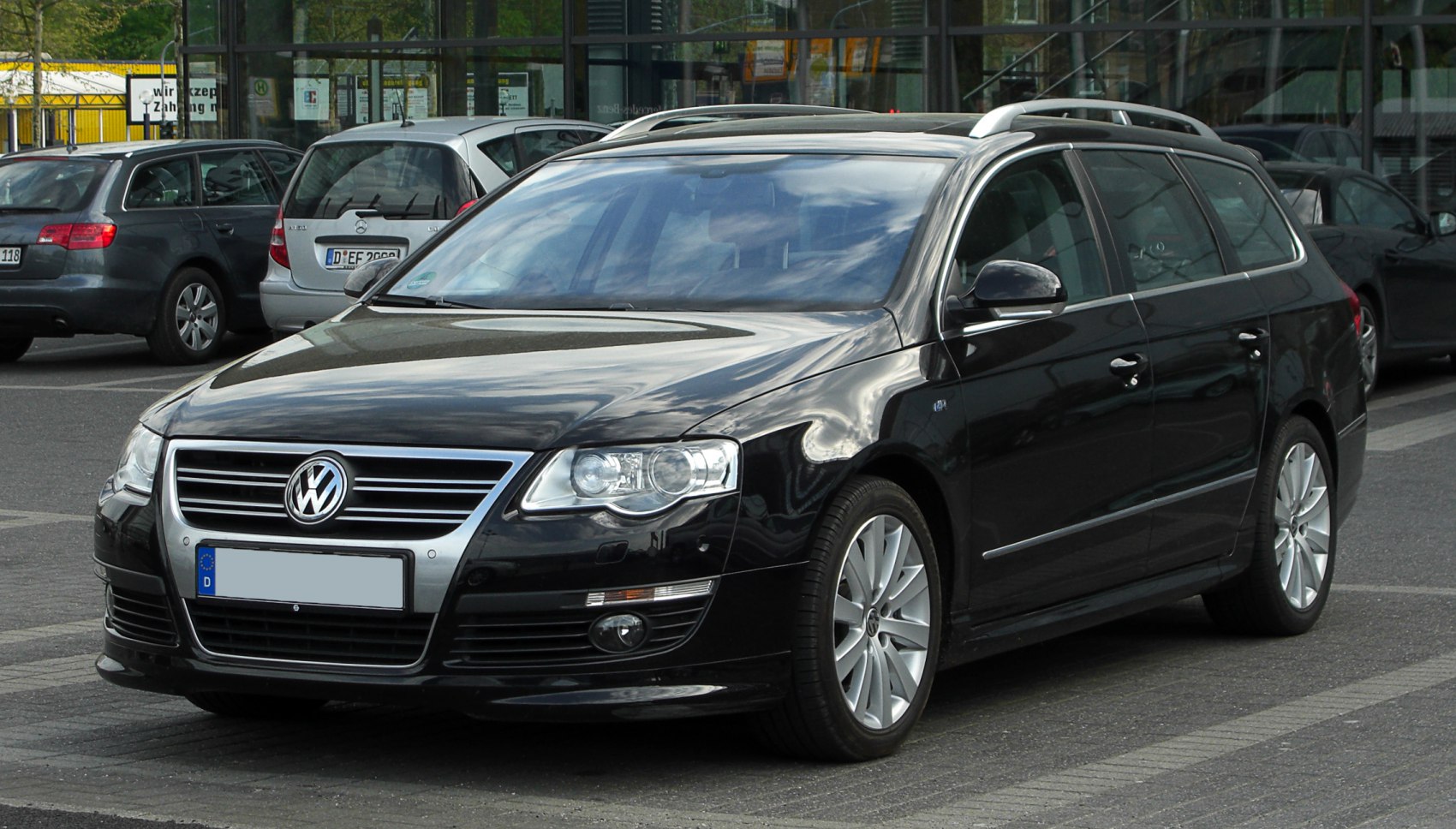 Front and side view of a black estate car with alloy wheels