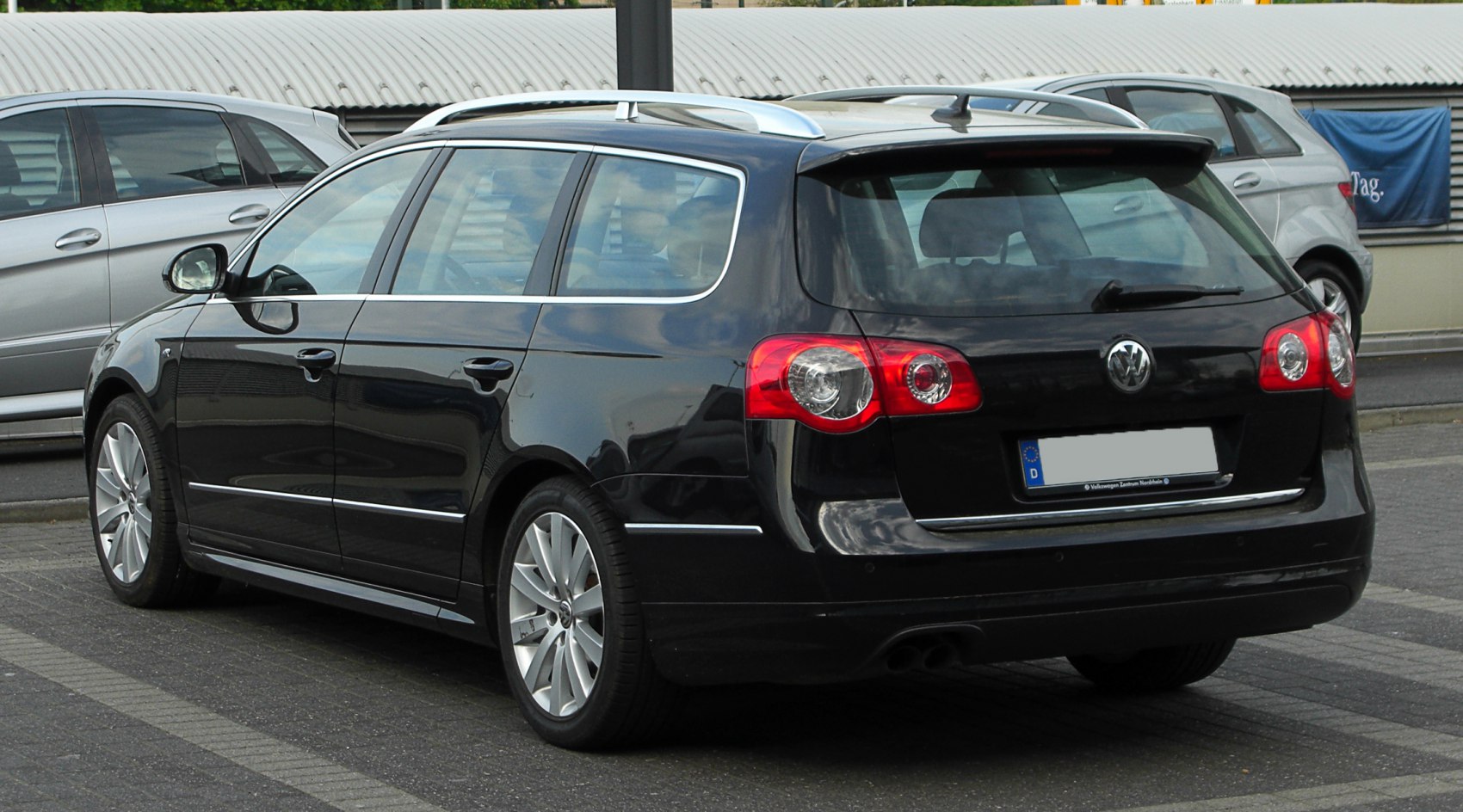 Rear and side view of station wagon with roof rails and distinct taillights