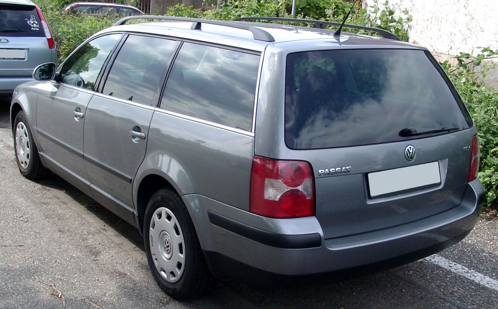 Rear and side view of a mid-2000s station wagon with roof rails and distinctive taillights