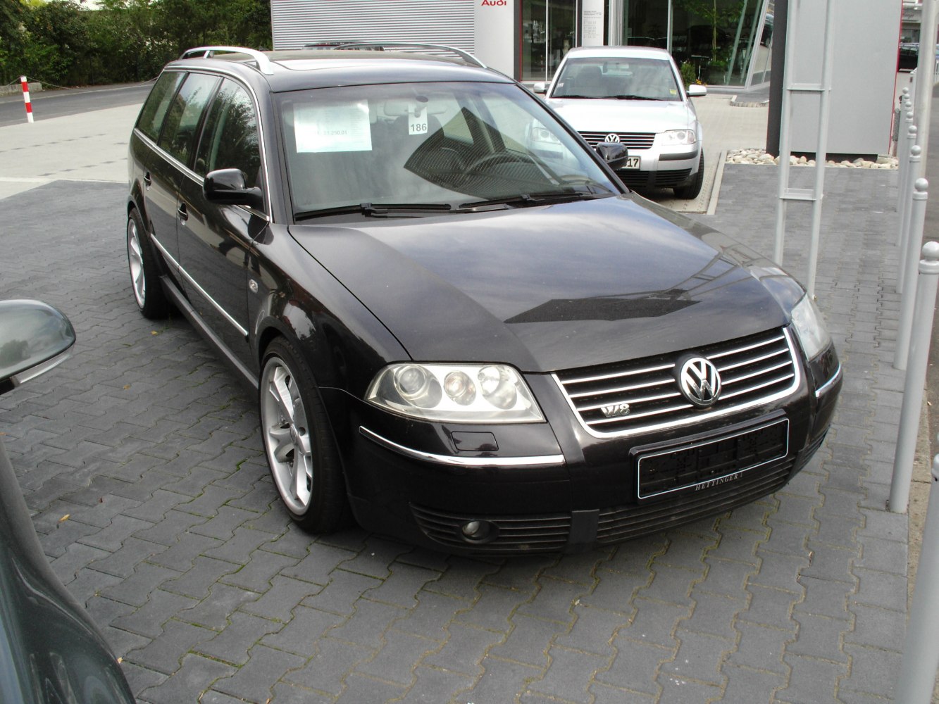 Front view with grille, headlights, and alloy wheels.
