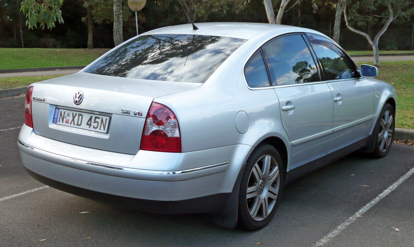 Silver sedan rear and side view with alloy wheels and distinct taillights