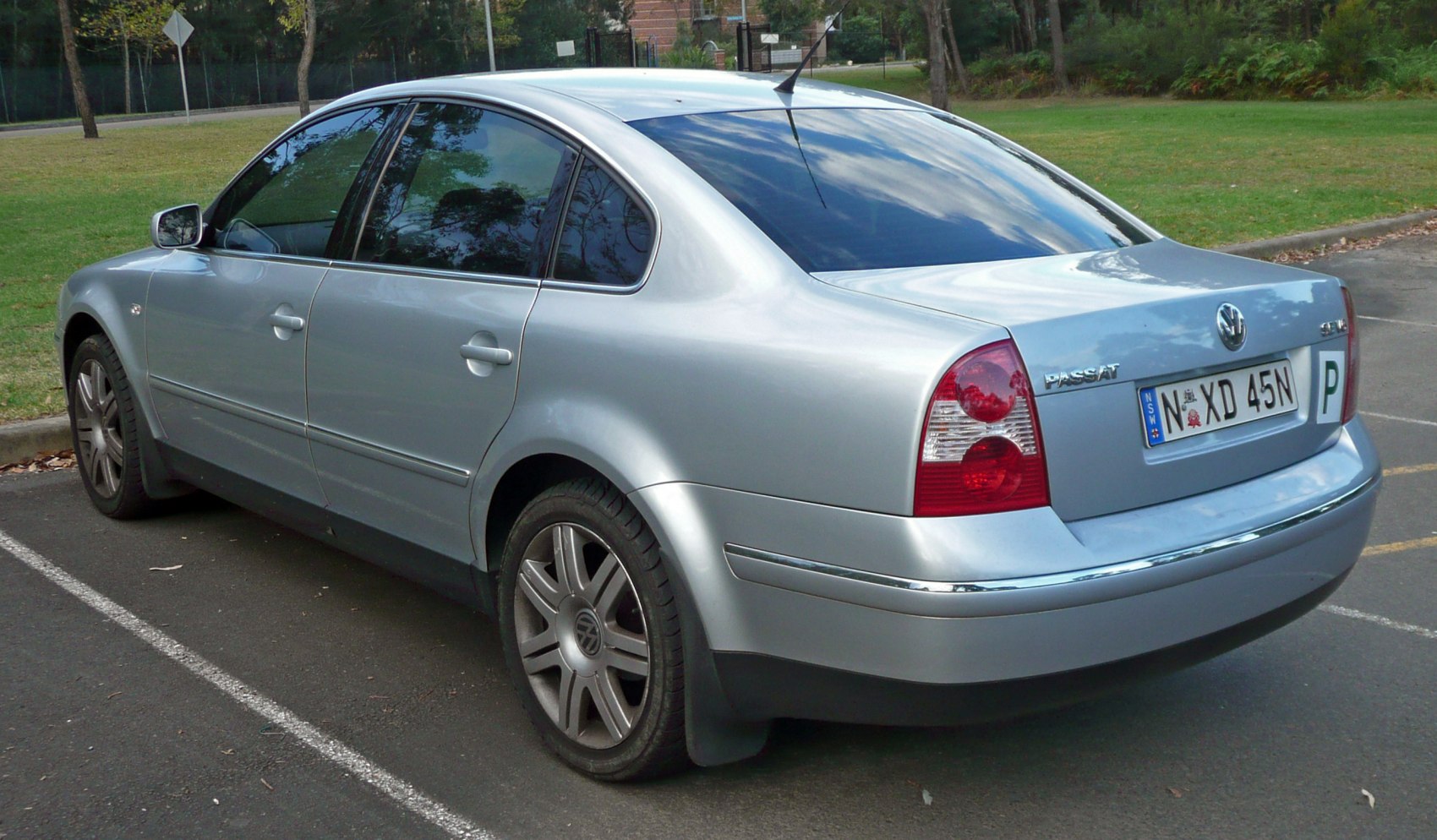 Rear side view of silver midsize sedan with distinct taillights and alloy wheels