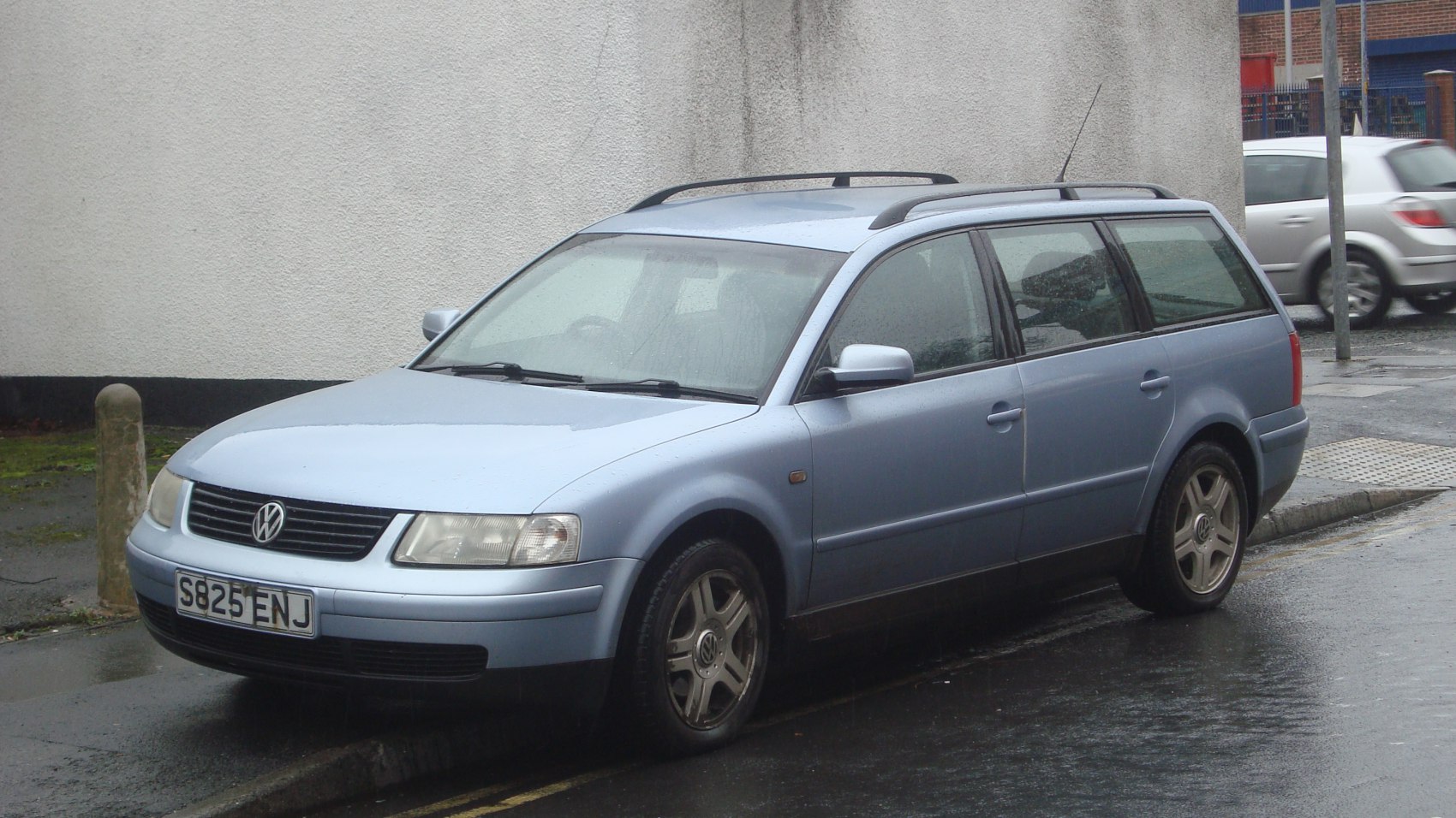 Front side view of a 1997 estate station wagon with roof rails